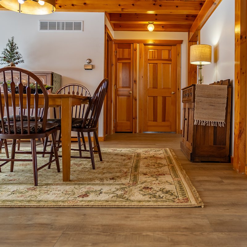 Living room in a New Providence, PA cabin with a custom-bound rug