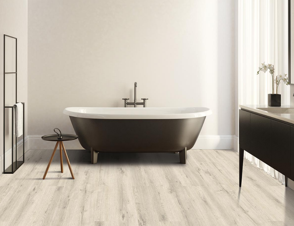 Light Pergo LVP wood-look flooring adds a natural look to a modern, sunny bathroom.
